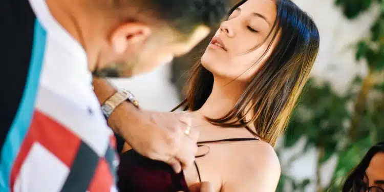 man holding woman's shirt