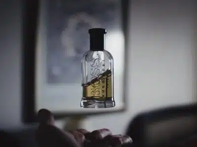 shallow focus photography of floating perfume bottle